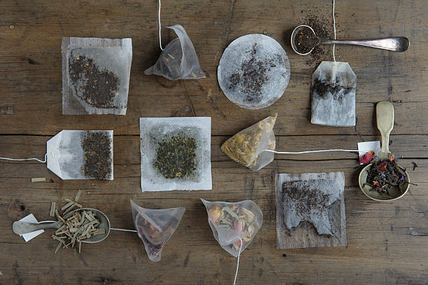 Various tea bags on a wooden board