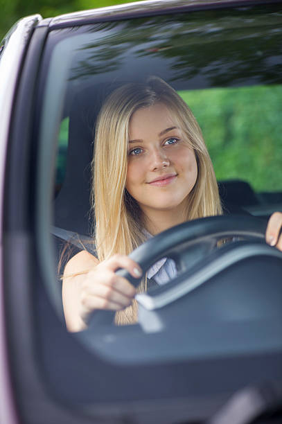 istock young woman driving her car 509921157