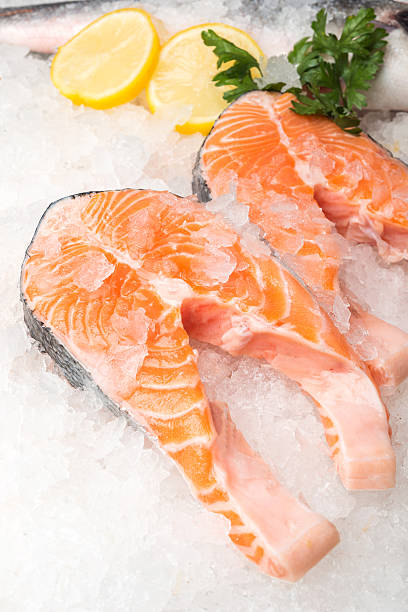 istock Fresh salmon fish with lemon on ice at market 509922960