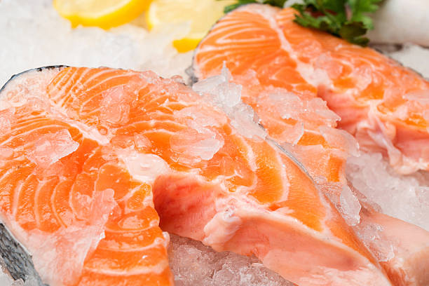 istock Fresh salmon fish with lemon on ice at market 509923306