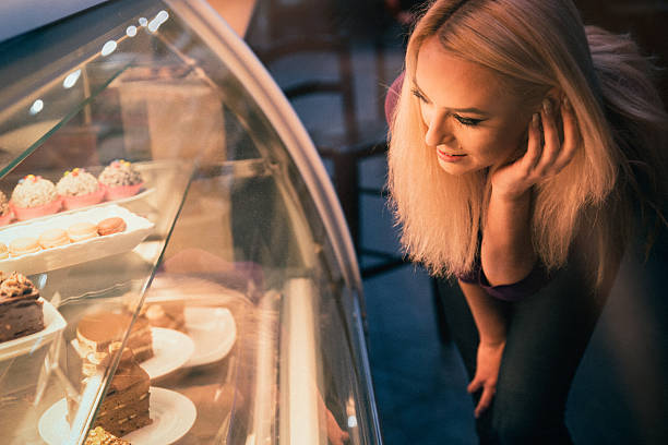 istock Young woman choosing a pastry in a bakery 509923526