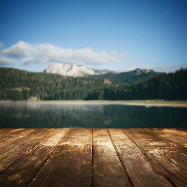 istock Wooden planks and defocused summer landscape on background 509923614