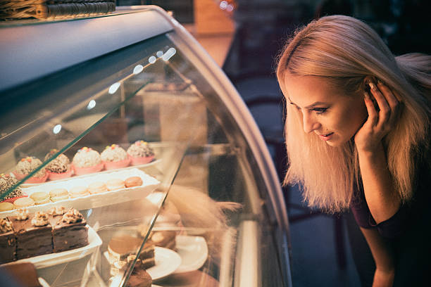 istock Young woman choosing a pastry in a bakery 509923616
