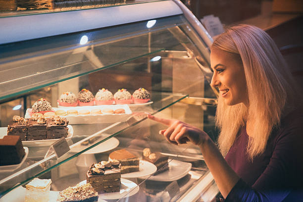 istock Young woman choosing a pastry in a bakery 509924416