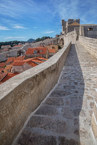 Walls of Dubrovnik Croatia Walls of Dubrovnik Croatia showing the stone pathway that encases the city dubrovnik walls stock pictures, royalty-free photos & images