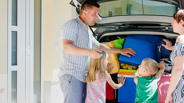 istock Family loading luggage into car 509930042