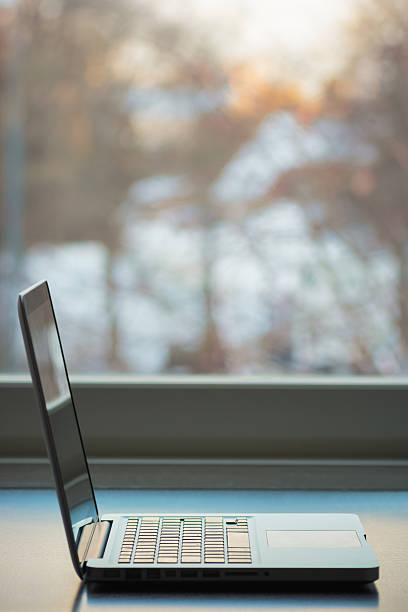 istock Laptop by a window in a bright winter day 509932662