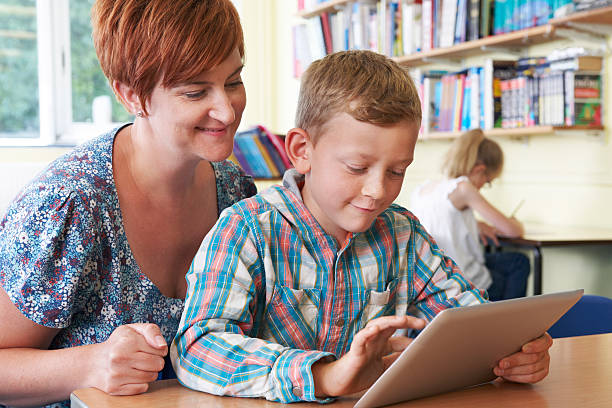 istock School Pupil With Teacher Using Digital Tablet In Classroom 509956831