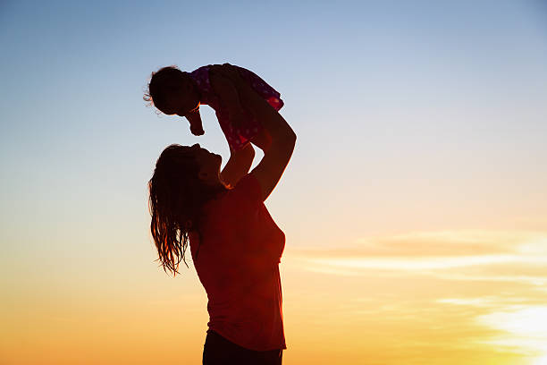 istock happy mother and baby having fun at sunset beach 509957717