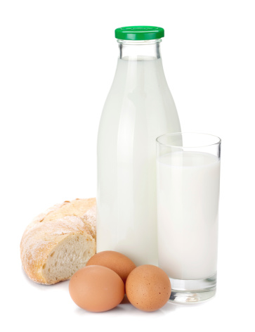 Milk bottle, glass, eggs and bread. Isolated on white background