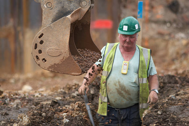 istock Digger Filling Ditch With Gravel On Construction Site 509959235