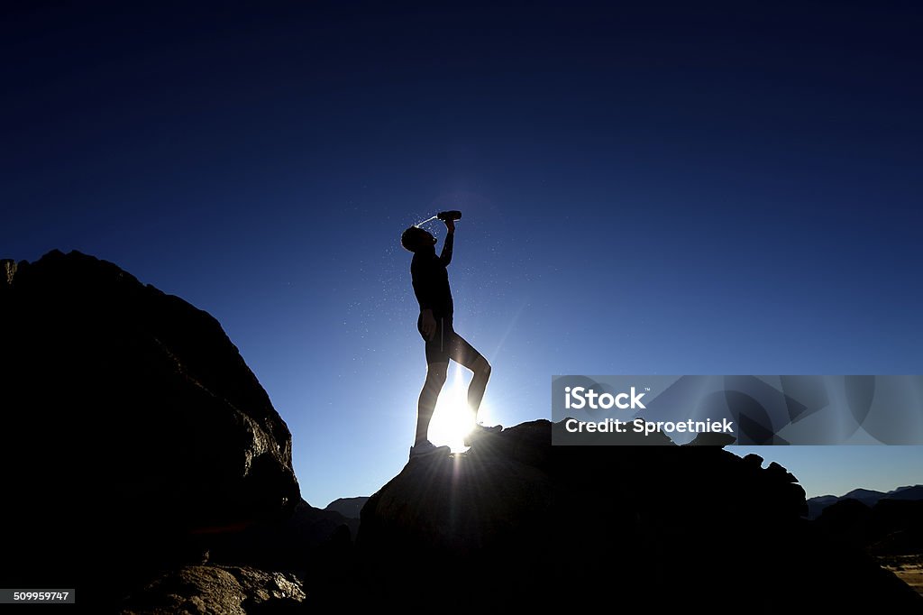 Silhouette of trail runner taking a break A trail runner takes a break on top of rocks characteristic of the South African and Namibian borders in the Northern Cape, South Africa Achievement Stock Photo