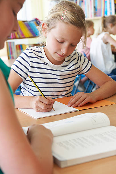 istock Elementary School Pupil Working At Desk In Classroom 509959943