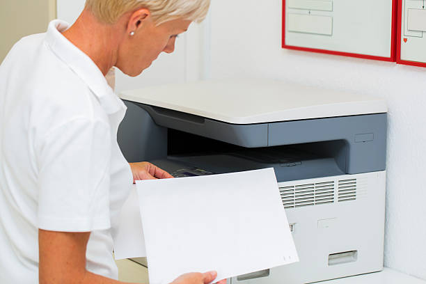 istock Nurse at work...using photocopier,copiing medical results 509961405