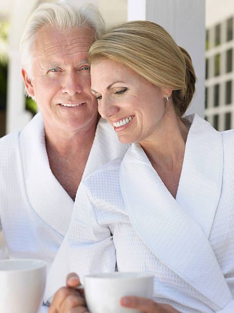 istock Couple In Bathrobes With Cups On Verandah 509963165