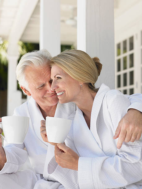 istock Couple In Bathrobes With Cups On Verandah 509963171