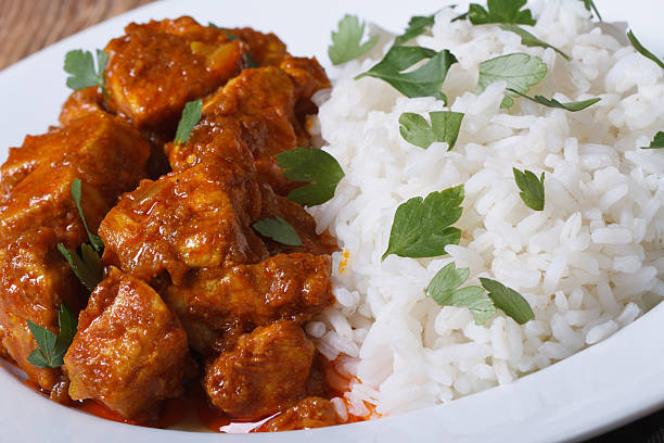 istock Rice with chicken curry and herbs closeup on plate 509980097