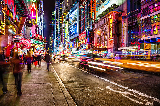 42nd street at night, New York City, USA Night life on busy 42nd street near 8th avenue in Middtown Manhattan, New York City. midtown manhattan stock pictures, royalty-free photos & images