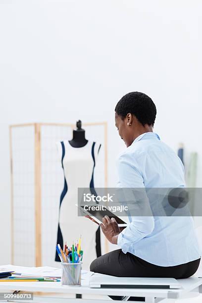 Female Fashion Designer Using Digital Tablet In Office Stock Photo - Download Image Now