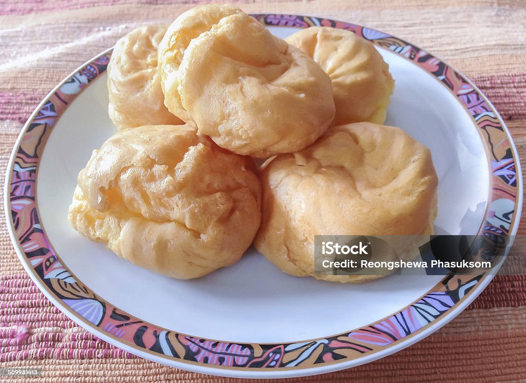 eclair - Brazillian Sweet eclair is an oblong pastry made with choux dough filled with a cream and topped with icing. Backgrounds Stock Photo