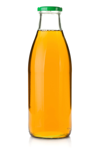 Apple juice in a glass bottle. Isolated on white background