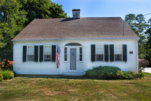 White Cape Cod house with green shutters in Wellfleet, Massachusetts
