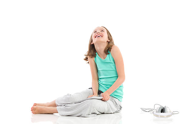 istock Smiling girl with multimedia looking up 509985385