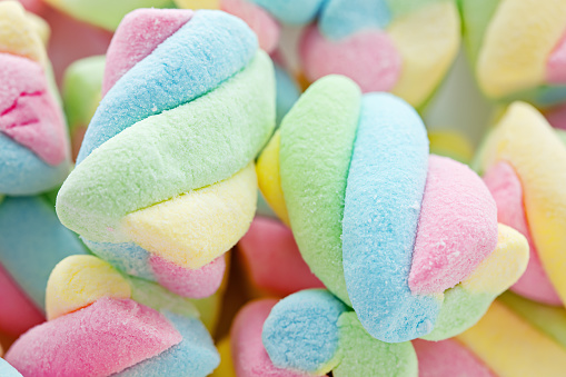 Background of twisted, colourful marshmallow, close up, macro