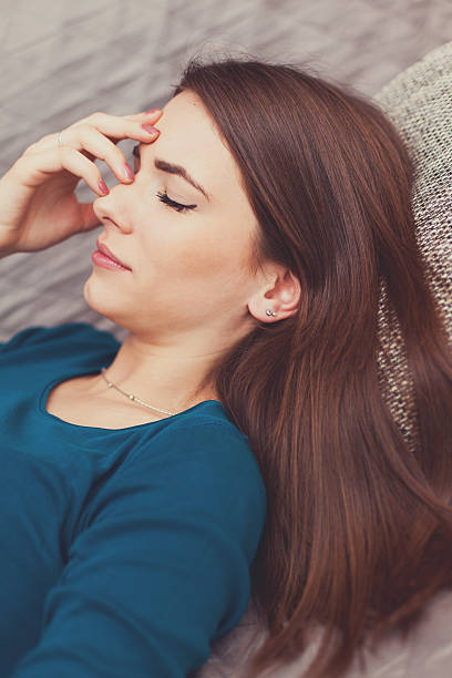 istock Woman with a head ache close up 509991198