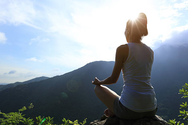 istock yoga woman practice on mountain peak 509992596