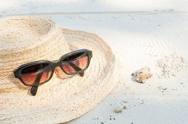 istock Straw hat and sun glasses on sand 509996816