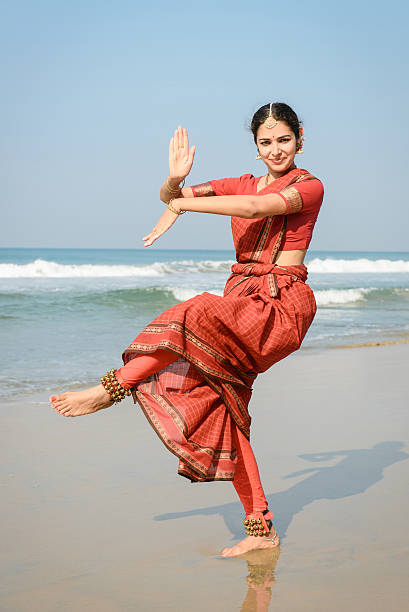 Beautiful indian woman dancer in traditional clothing Beautiful indian woman dancer in traditional clothing near the beach bharatanatyam dancing stock pictures, royalty-free photos & images