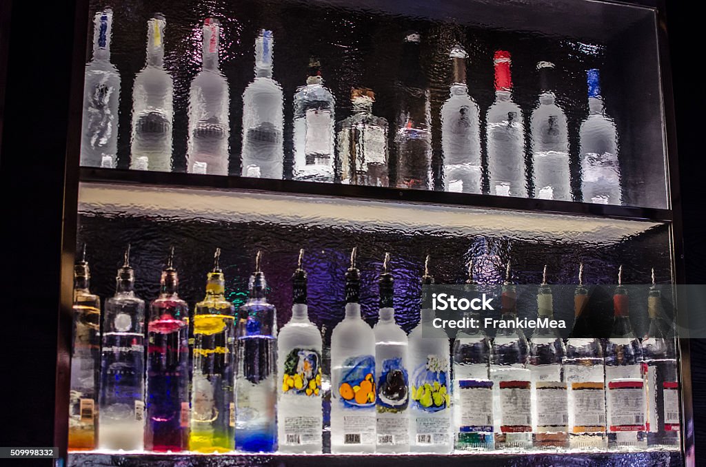 Back of a bar shelf through rippled glass Vodka Stock Photo