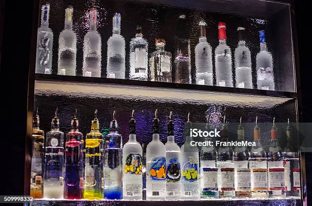 Back Of A Bar Shelf Through Rippled Glass Stock Photo - Download Image Now - Vodka, Bottle, Bar - Drink Establishment