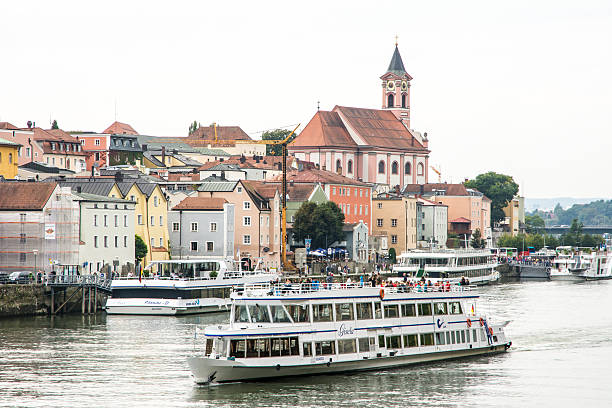 Passau, Germany - August 23, 2014:Passenger ships on the Danube river in Passau. Passau is also called the City of Three Rivers (Danube, Ilz and Inn). Foto taken from Prinzregent-Luitpold bridge.