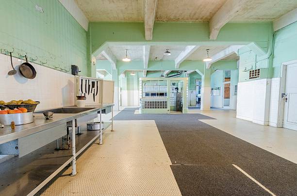 Alcatraz Dining Hall, San Francisco, California The Dining Hall kitchen inside the cellhouse on Alcatraz Penitentiary island, now a museum, in San Francisco, California, USA. A view of kitchen where the food used to be prepared for prisoners to eat. prison meal stock pictures, royalty-free photos & images