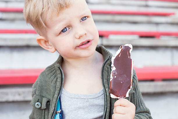 istock Kid eating chocolate ice cream outdoor 510011469