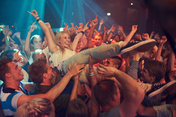 Own the night Cropped shot of a woman crowd surfing at a music festival mosh pit stock pictures, royalty-free photos & images