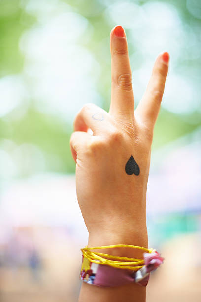 Make your statement A young woman with a heart tattoo on her hand wrist tattoo stock pictures, royalty-free photos & images