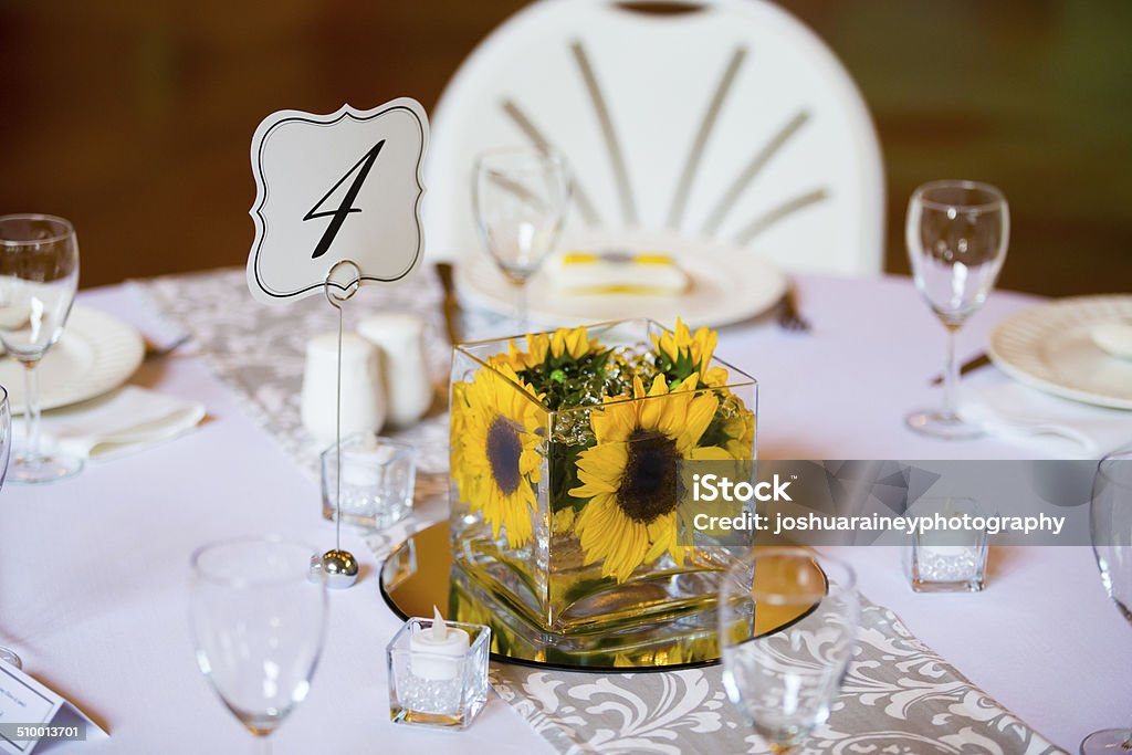 Wedding Table Centerpieces with Flowers Flowers in glass on the tables for the centerpieces at this indoor wedding reception. Arranging Stock Photo