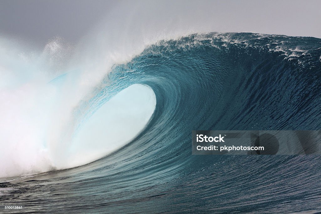 Big blue surfing wave Big blue surfing wave breaking over coral reef in the Mentawai Island, Sumatra, Indonesia Wave - Water Stock Photo