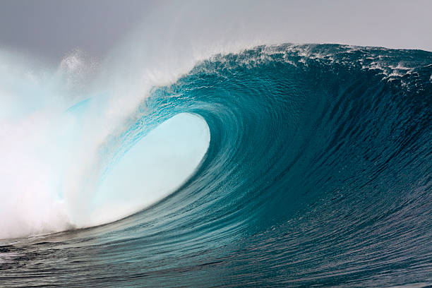 Big blue surfing wave Big blue surfing wave breaking over coral reef in the Mentawai Island, Sumatra, Indonesia Mentawai Islands stock pictures, royalty-free photos & images