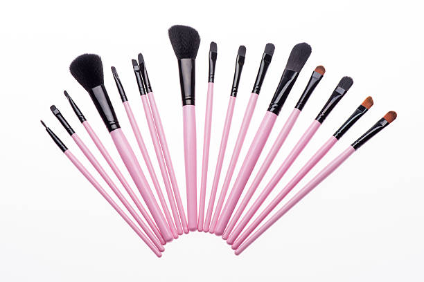 istock Set of  professional  pink make-up brushes isolated on white 510014115