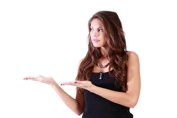 istock Young brunette woman shows and looks to left 510014570