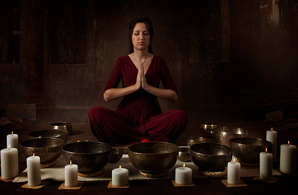 istock Young woman with Tibetan bowls 510014572