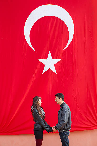 istock Couple Holding Hands In Front Of The Turkish Flag 510015840