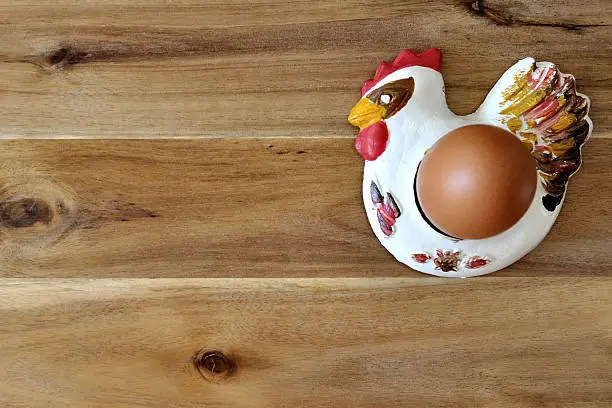 egg in an egg holder on a wooden table