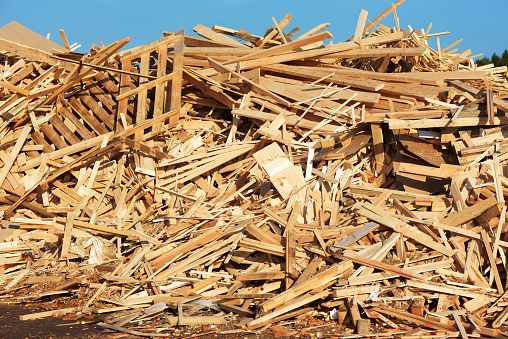 A large pile of wooden debris mostly from planks and pallets.