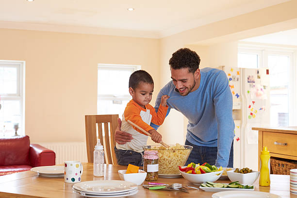 istock Father And Son Making Pasta Salad In Kitchen 510019414