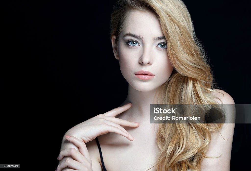 Perfect skin. Close-up of an attractive girl Beautiful Girl face. Perfect skin. Close-up of an attractive girl of European appearance on dark background. Teenage Girls Stock Photo